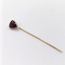 A late 19th/early 20th century yellow metal, garnet and seed pearl stick pin Provenance: From a