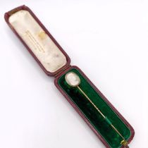 A late 19th/early 20th century stick pin, inset with cameo of a man, in a vintage jewellery box