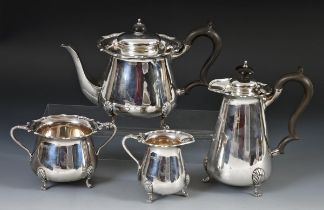 An Edward VII silver four piece tea set, comprising a hot water jug, teapot, cream jug and a sugar