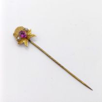 An early 20th century yellow metal, pink stone and seed pearl stick pin Provenance: From a single