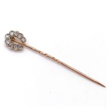 A late 19th/early 20th century yellow metal and diamond stick pin, in the form of a horseshoe