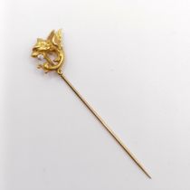 A late 19th/early 20th century yellow coloured metal and diamond stick pin, in the form of a