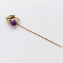 An early 20th century yellow metal, amethyst and seed pearl stick pin Provenance: From a single