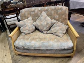 An Ercol three piece suite, comprising a two seater sofa, and two armchairs (3)