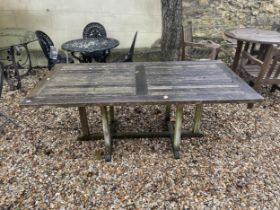 A garden table, 180 cm wide, weathered