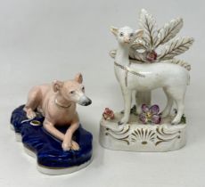 A 19th century Staffordshire quill holder, in the form of a greyhound, 14 cm wide, and a