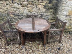 A teak garden table, 122 cm diameter, and three chairs (4)