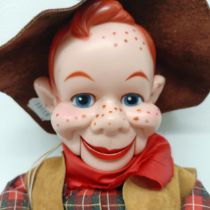 A Howdy Doody cowboy ventriloquist dummy, with a leather hat, waistcoat, chaps and holster, 63 cm