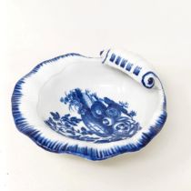 An early Worcester blue and white shell form bowl, decorated still life of fruit, crescent moon mark
