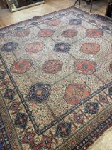 A Persian style cream ground carpet, 330 cm wide