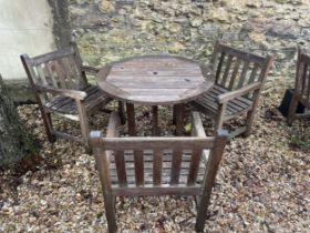 A teak garden table, 90 cm diameter, and three chairs (4)