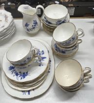 A Minton part blue and white service, comprising a jug, sugar bowl, eight cups, six saucers, and