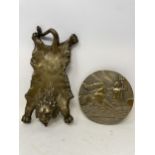 A brass pin tray, in the form of a lion skin, and a plaque (2)