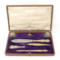 A 19th century gilt metal writing set, comprising inkwells, seal, pencil and two knives, in a