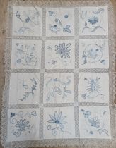 A table cloth, with blue embroidered decoration (box)