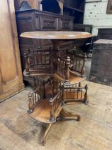 A walnut revolving bookcase, on a tripod base, 45 cm diameter