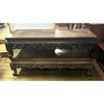 A pair of Chinese low tables, with carved friezes, 141 cm wide (2) One of the pieces of the top is