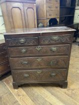 An oak chest, having two short and three long drawers, 100 cm wide, a wall hanging cupboard and a