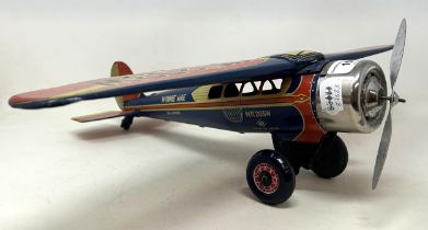 A Japanese wind up tinplate aeroplane, 41 cm wide key winds as expected, undercarriage wheels go
