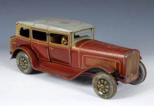 A German TippCo clockwork tinplate limousine, with a chauffeur, in red livery having Dunlop tyres