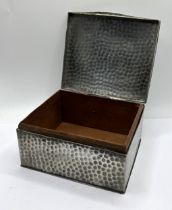 A pewter table cigarette box, with hammered decoration, the lid applied a Royal Engineers plaque,