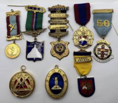Assorted military badges, Masonic medals and other items in an album