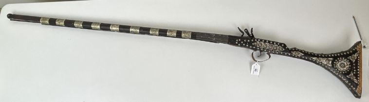 A 19th century Moroccan flintlock gun, 145 cm long Fair rather than good condition, rusty in
