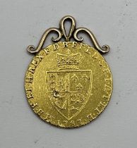 A George III gold spade guinea, 1787, with a later yellow metal mount