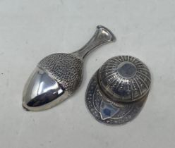 A novelty silver caddy spoon, in the form of a cap, another in the form of an acorn (2) Condition