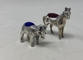 A novelty silver pin cushion, in the form of a donkey, and another in the form of a horse (2)