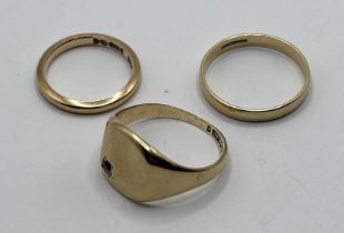 A 9ct gold signet ring, ring size P, a 9ct gold wedding band, ring size P 1/2, and a 9ct gold