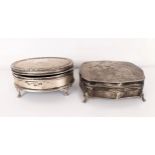 A George V silver oval dressing table box, and another (2)