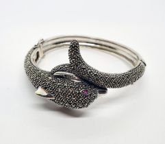 A silver and marcasite dolphin form bangle Condition good, a 20th/21st century copy