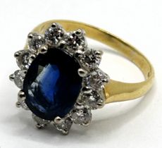 An 18ct gold, sapphire and diamond cluster ring, ring size P Sapphire approx. 10.9 x 8.4 mm, and 3.9