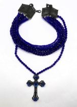 A Jean Paul Gaultier blue bead triple thread necklace, with a cross pendant Metal untested Beads are