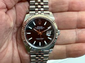 A gentleman's Rolex Oyster Perpetual DateJust 41 steel black baton dial wristwatch, with a white