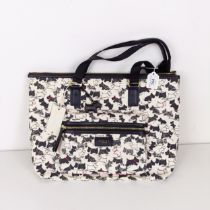 A Radley handbag, with a black and white Scottie dog pattern, new and unused plastic covered fabric