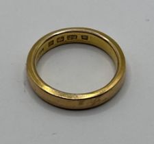 A 22ct gold wedding band, ring size J, 6 g