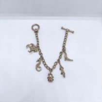 A silver gilt charm bracelet, and assorted charms Not all charms marked or tested. NOTE Chain silver