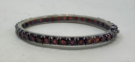 A silver and garnet bangle Condition good, a 20th/21st century copy