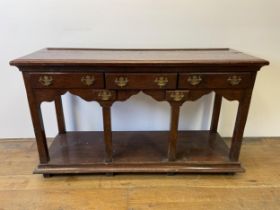 A George III oak dresser base, with five drawers and a potboard base, 131 cm wide Height - 77 cm