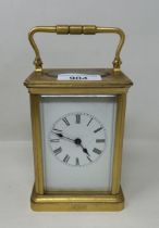 A carriage clock, in a brass and glass case, 18 cm high
