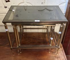 A nest of three brass tables, with glass tops, 53 cm wide