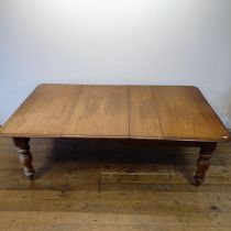 A mahogany extending dining table, on turned legs, the top 106 x 120 cm, with two extra leaves, 60