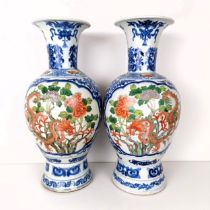 A pair of Chinese blue and white vases, the central cartouche decorated with dragons, 47 cm high (2)