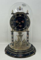 A mantel clock, with an eight day movement, in a glass dome, 33 cm high Various wear to the base