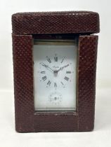 A carriage clock, by Angelus, with a repeat and an alarm, in a faux snake skin travel case, 20 cm