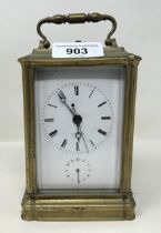 A carriage clock, with a repeat and an alarm, in a brass and glass case, 16 cm high