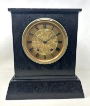 A mantel clock, with an eight day movement, in a slate case, 27 cm wide Has a key, mechanism winds