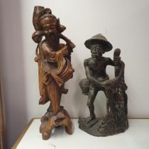 A Chinese carving of a figure, converted to a lamp base, 55 cm high, and an Eastern carving of a